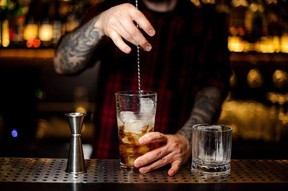 Amehla Co stainless steel extra long bar spoon being used to stir down a cocktail.