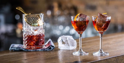 Amehla Co. traditional nick and nora cocktail glasses with Negronis in them being served 'UP'