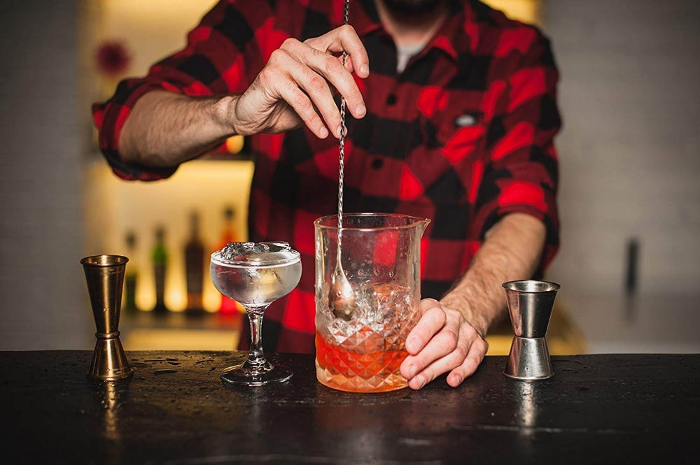 Amehla Co stainless steel extra long bar spoon being used to stir down a cocktail.