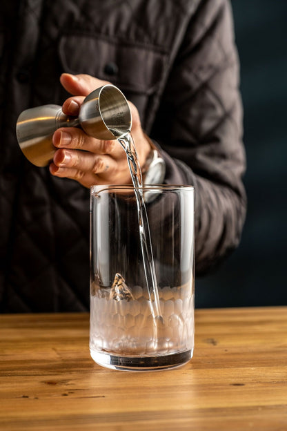 Clear Liquor being poured into Honeycomb Mixing glass. Photo by Jordan Hughes of High Proof Preacher.