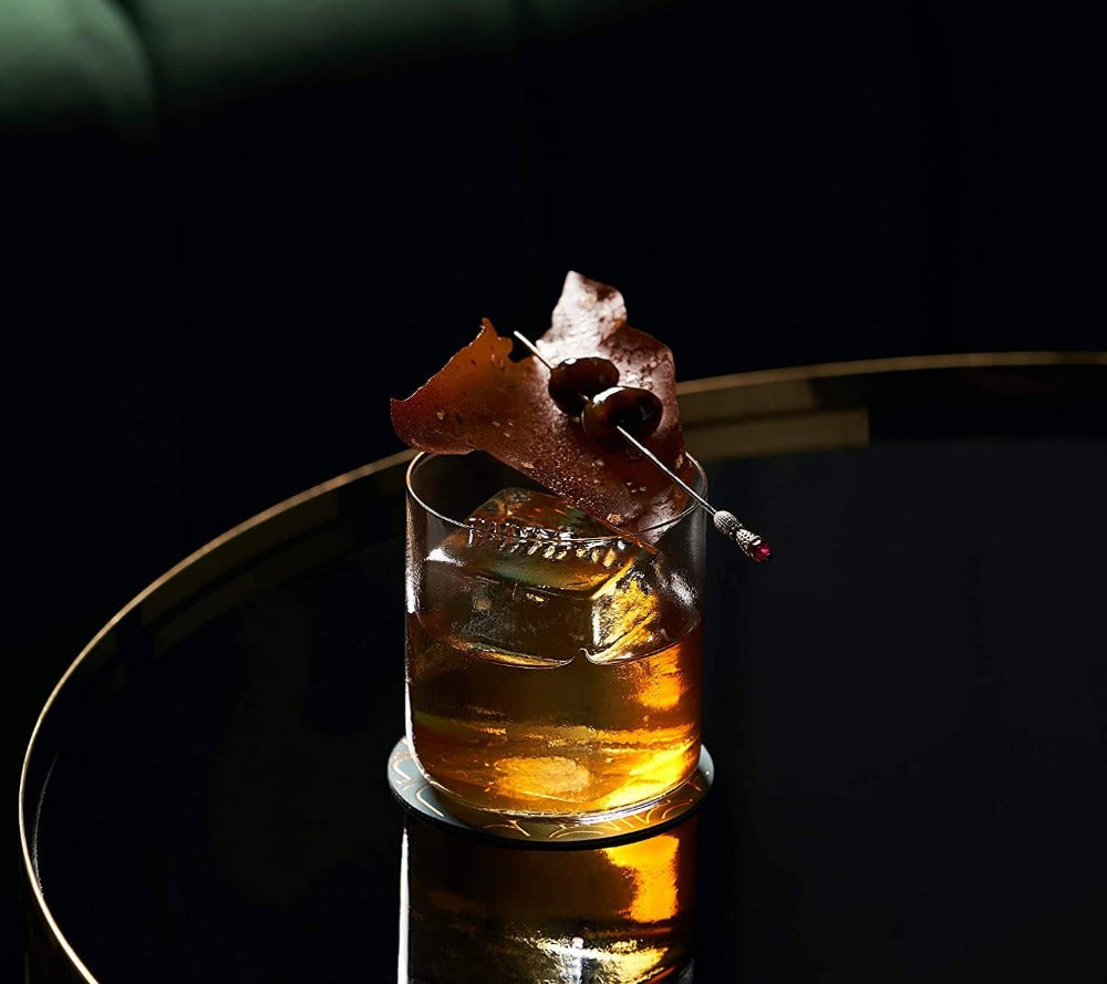 cocktail in an ultra thin old fashioned glass with impressive garnish