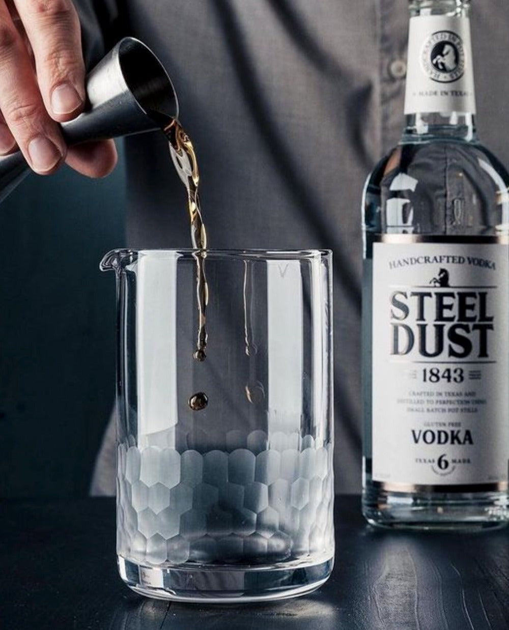 dark liquid being poured into an Amehla Co Honeycomb mixing glass. Photo from Jordan Hughes of High Proof Preacher.